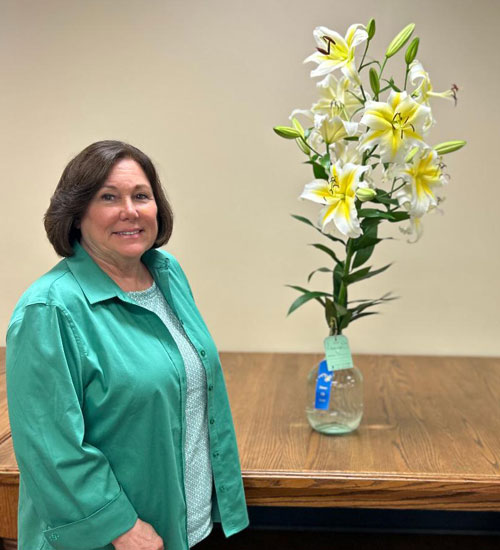 Anna Fortune poses proudly with her prize-winning lily